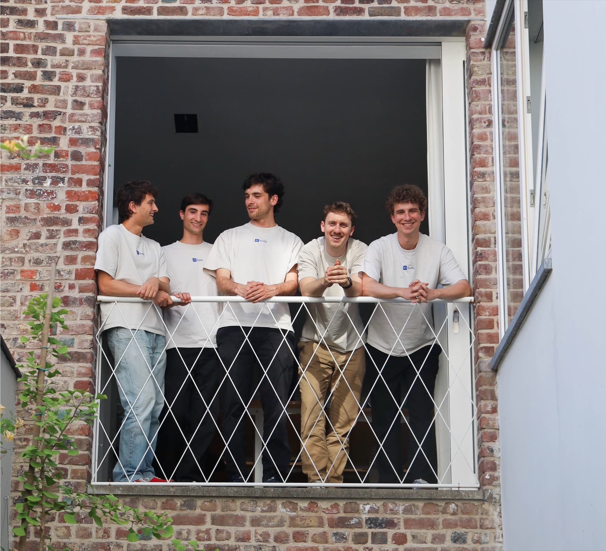 The Duely team at the office window in Ghent
